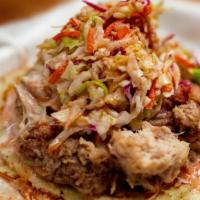 Pulled Pork Redneck Taco · Cornbread Hoecake Topped with Pulled Pork and Slaw. Choice of Sauce on Side