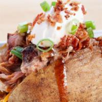 Bbq Baked Potato · Baked potato topped with your choice of pork, turkey, or chicken with chopped bacon, shredde...