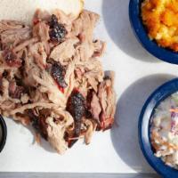 Pulled Pork Shoulder Tray · Includes two sides and served with White Bread.
