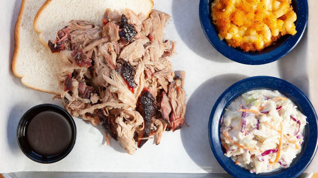 Pulled Pork Shoulder Tray · Includes two sides and served with White Bread.