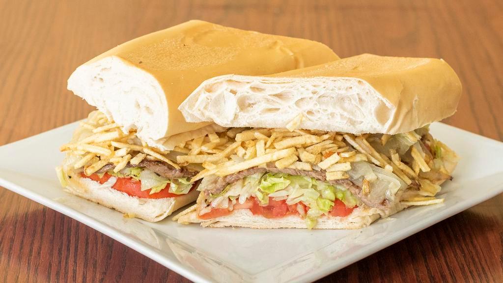 Pan Con Bistec · Steak sandwich. Grilled with onions julienne fries and garnished with tomatoes and lettuce on Cuban bread.