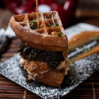 The Waffle Sandwich · Cornbread waffle, fried chicken, mac & cheese, greens, sweet potato sauce. Served with fries.