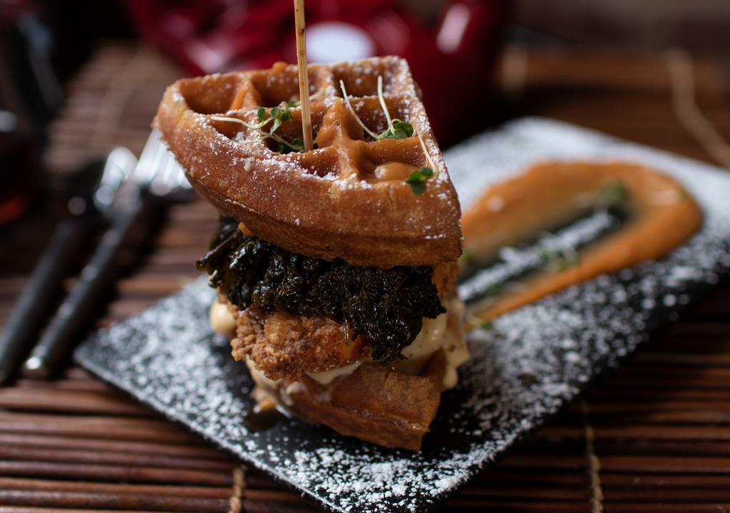 The Waffle Sandwich · Cornbread waffle, fried chicken, mac & cheese, greens, sweet potato sauce. Served with fries.