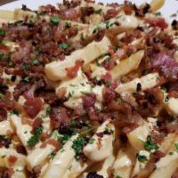 Loaded Fries · A generous portion of our fries smothered in white queso and topped with crispy bacon, chive...