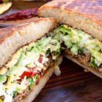 Tortas · Mexican Sandwich, Four Cheese, Cilantro, Onions, Tomatoes, Lettuce, Avocado, Table Cream and...