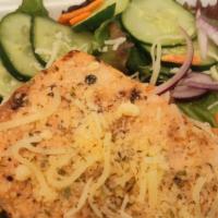 Parmesan Salmon Salad · Grilled salmon with Parmesan crust on a bed of garden fresh veggies, served with house dress...