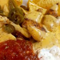 Grilled Chicken Nachos · Marinated diced chicken breast, house salsa, sour cream, jalapenos, smothered in house queso