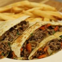 Steak Quesadilla · Grilled steak with peppers, onions, and cheddar cheese served in a grilled tortilla with sou...