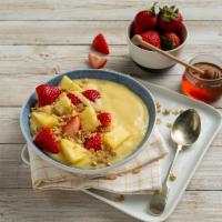 Tropical · Blended yogurt, banana and mango, topped with strawberries, pineapples, granola, and honey. ...