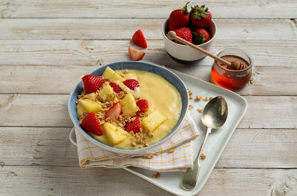 Tropical · Blended yogurt, banana and mango, topped with strawberries, pineapples, granola, and honey. Cal. 380.