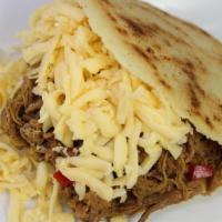 Arepa Pelua · Arepa stuffed with shredded beef and Gouda cheese.