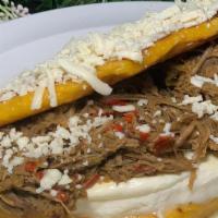 Shredded Beef Cachapa · Traditional Venezuelan sweet corn meal pancake with soft white cheese and shredded. beef