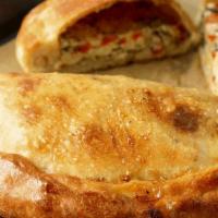 Veggie Calzone · Fresh mushrooms, onions, green peppers, and black olives stuffed in a freshly baked crust wi...