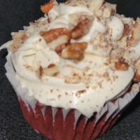 Red Velvet With Nuts · Red cocoa cake frosted with cream cheese frosting and pecan topping.