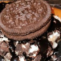 Oreo Cheesecake · Creamy cheesecake layered with Oreo cookies, topped with Oreo cookies and chocolate syrup.
