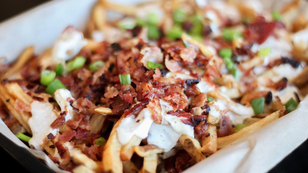 Pub Grub · Fresh cut chips, or fries topped with homemade beer cheese, chopped bacon and garnished with diced green onions.