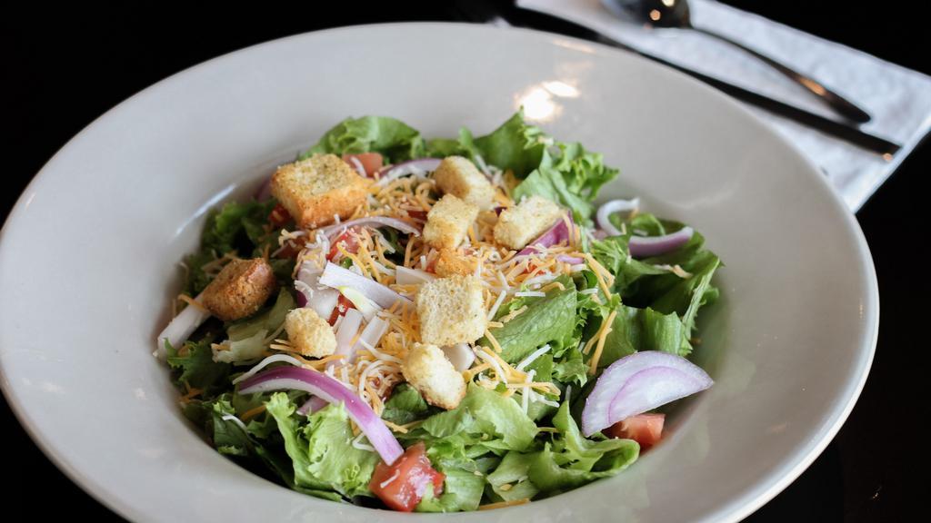 House Salad · Crisp greens topped with tomato, onion, shredded cheese and croutons.