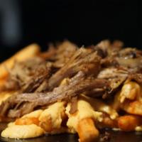Next Level Cheesy Fries · Cheesy Fries topped with juicy and smoky pulled pork.