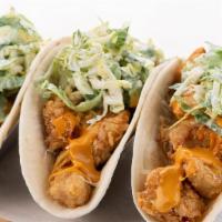 Fried Chicken Taco · Fried chicken tender served topped with grilled corn chipotle coleslaw.