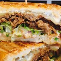 Barbacoa Torta · Specially marinated shredded beef brisket, pepper jack cheese, pickled red onions, lettuce, ...