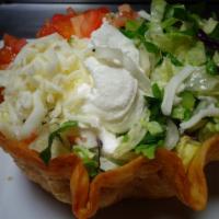 Taco Salad · Shredded chicken or ground beef, with lettuce, tomatoes, shredded cheese and sour cream.