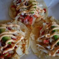 Fish Tacos · Three soft corn tortillas filled with white fish, pico de gallo, cabbage, homemade tartar sa...