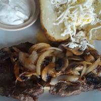 Steak Loco · A ribeye steak topped with butter, grilled onions, and mushrooms. served with a bake potato ...