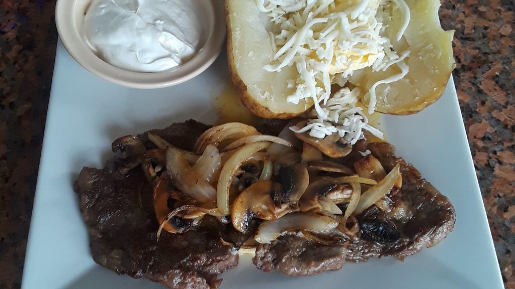 Steak Loco · A ribeye steak topped with butter, grilled onions, and mushrooms. served with a bake potato or vegetables.