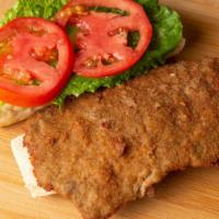 Milanesa A Caballo · Breaded chicken or steak with two fried eggs on top.