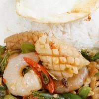 Spicy Basil Seafood · Shrimp, squid, basil leaf, Thai spicy basil sauce, fried egg, jasmine rice