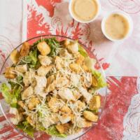 Chicken Caesar Salad · Romaine lettuce, Parmesan cheese, croutons and grilled chicken strips.