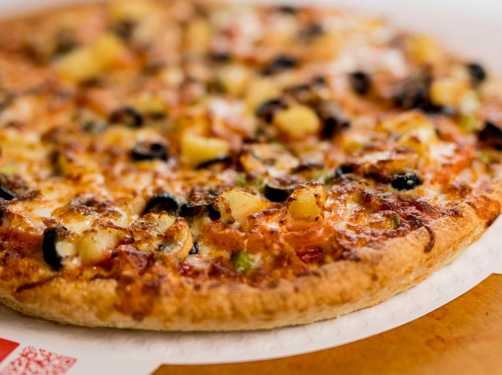 Vegetarian Pizza · Green peppers, onions, fresh tomatoes, black olives, mushrooms, sweet pineapple and Sarpino's gourmet cheese blend.