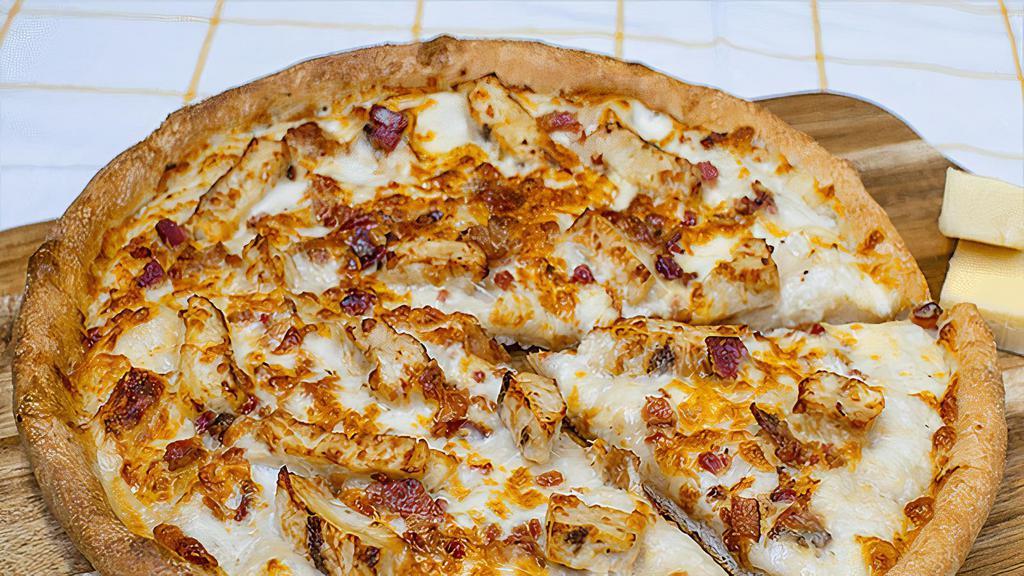 Alfredo Chicken · Sarpino's traditional pan pizza baked to perfection and topped with tender chicken strips, crispy bacon, Parmesan, our signature gourmet cheese blend, and creamy alfredo sauce.