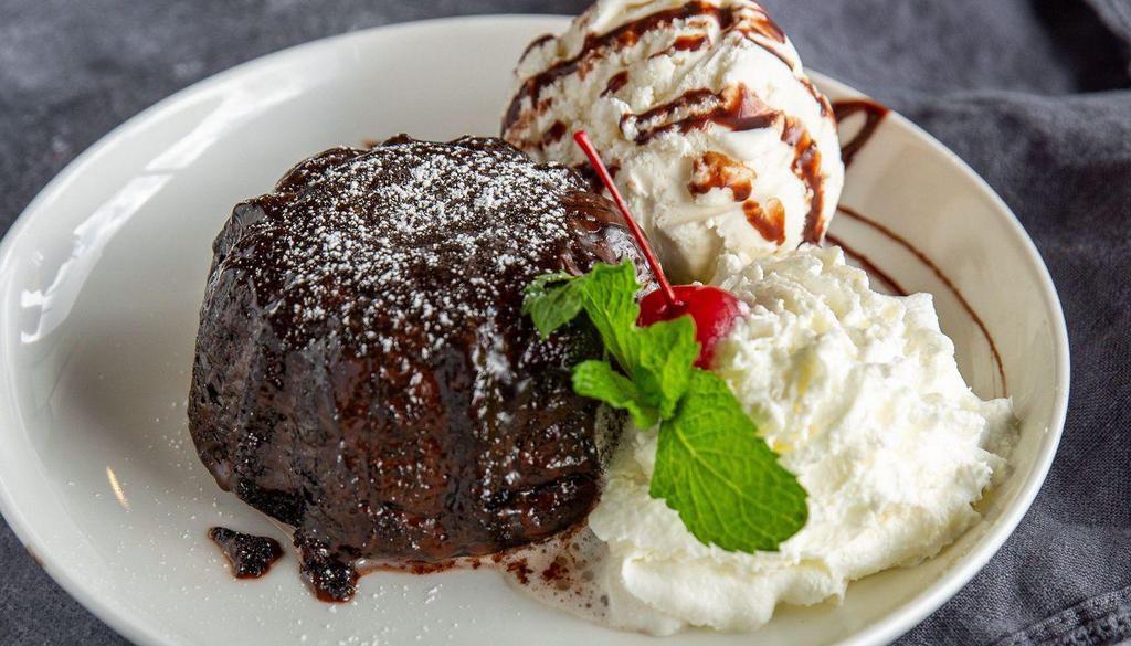 Molten Chocolate Cake · Our moist dark chocolate cake enrobed  with dark chocolate... filled with dark chocolate truffle that melts out. serve with vanilla ice cream