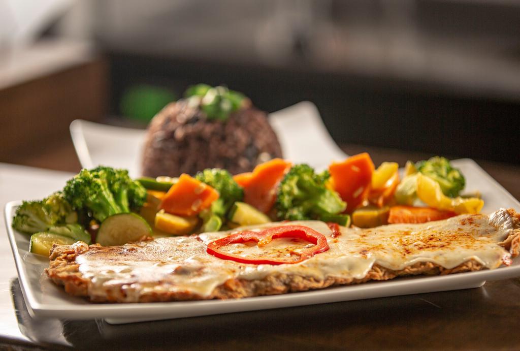 Bistec Milanesa Especial · Milanesa steak with ham and cheese.