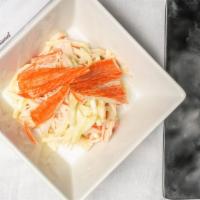 Kani Salad · Crabmeat with cucumber mixed with mayo and masago toppted with avocado and sesame seed.