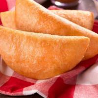 Empanada (Fried) Pabellon · Fried Venezuelan style cornmeal empanada filled with shredded beef, shredded chicken or cazo...