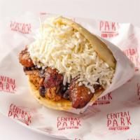 Arepa Pabellon · Arepa filled with yellow plantain, black beans, shredded beef, and white cheese.