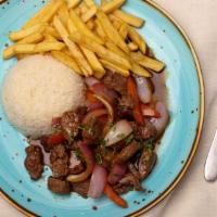 Lomo Saltado · Tenderloin cubes flambeed in a wok for a culture extravaganza finished off with red onion, t...