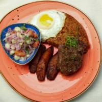 Tacu Tacu A Lo Pobre · Golden tacu tacu with 9 oz of grilled flat meat steak, sweet plantains, fried egg, and criol...