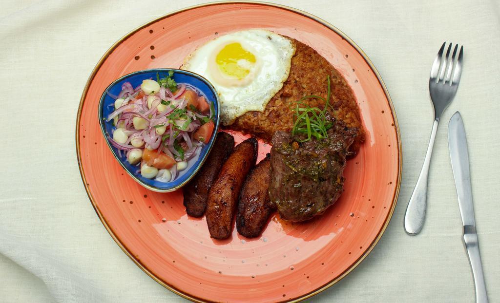 Tacu Tacu A Lo Pobre · Golden tacu tacu with 9 oz of grilled flat meat steak, sweet plantains, fried egg, and criolla sauce.