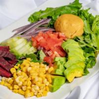 Regal Salad · Organic Spring mix, Beets, Corn, Cucumber, tomato, Hummus and homemade Shallot dressing.
