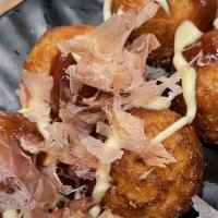 Takoyaki · Fried octopus ball topped with japanese mayo and bonito flakes.