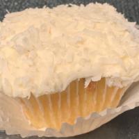 Coconut Cupcake · A coconut cupcake topped with cream cheese frosting and then dipped in shredded coconut.