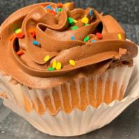 Vanilla/Chocolate Cupcake · A Vanilla cupcake with chocolate buttercream frosting and seasonal sprinkles.