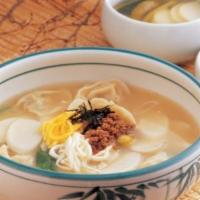 Duk Man Doo Guk (떡만두국) · Beef soup with meat dumplings, slices of rice cake and egg.