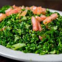Tabouli · A mix of chopped parsley, tomatoes, onions, green onions, burgul (cracked wheat), spices, he...