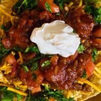 Nachos · Corn Chips topped with meatless crumbles, fresh cilantro and tomatoes, mild salsa,  Vegan sh...