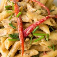 Rasta Pasta · penne pasta, in a spicy cheesy creamy sauce with a veggie melody topping.