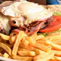 Chivito Uruguayo · Grilled steak with tomatoes, lettuce, ham, bacon, onions, melted cheese, a fried egg with Fr...